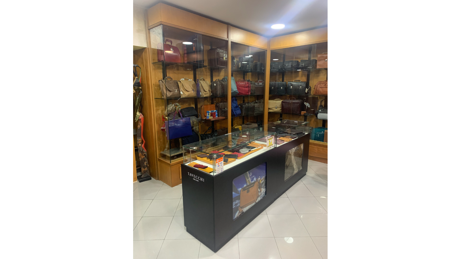 <p>A glimpse of the entrance to the company's offices: note the wide selection of leather goods and the Tavecchi Milano logo, a brand recently acquired by Silan Promozioni</p>